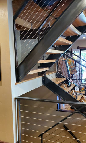 Photo of open stairs with wood treads, metal stringers and metal railings