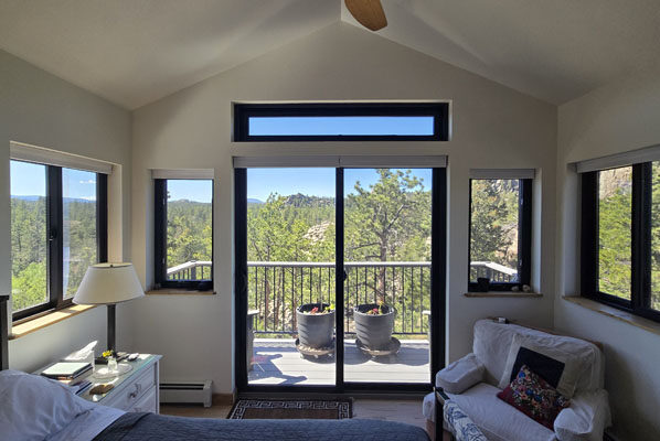 photo of inside of bedroom with vaulted ceilings and panoramic views