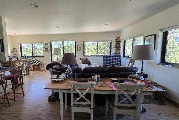 photo of living room with lots of windows with expansive mountain views