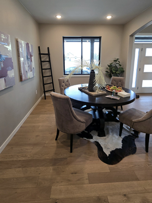 photo of a dining room with wood floors and a round table