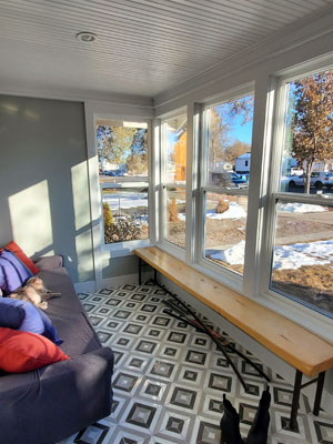 photo of sunroom windows and bench with blue geometric tile floor
